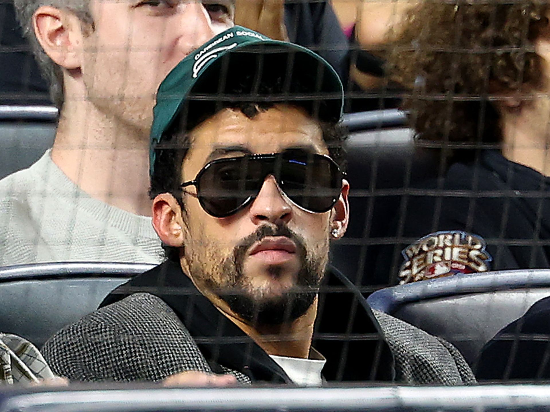 Bad Bunny protects his beautiful face as a foul ball flies at him at the Yankees game