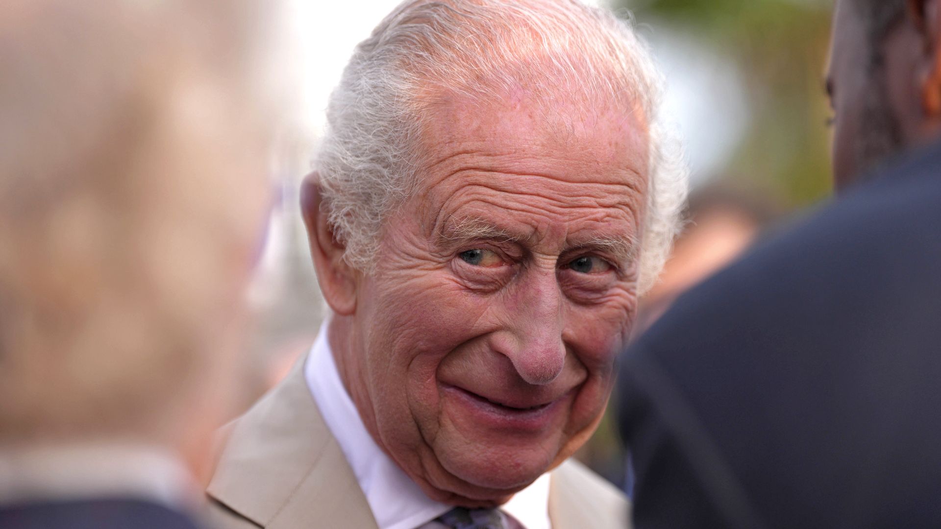 King Charles III descends from the aircraft upon arrival in Bermuda, marking a historic first visit as monarch.