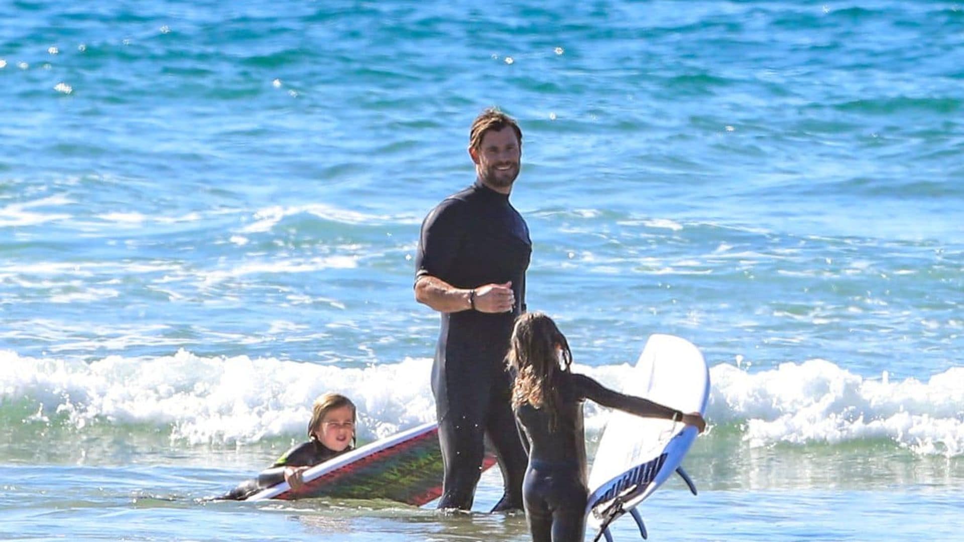 Chris Hemsworth showed off his toned muscles while surfing with his kids