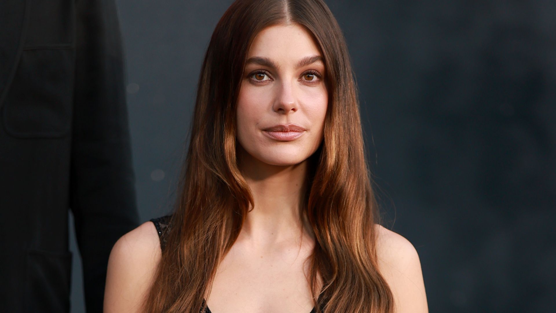 Camila Morrone turns heads in white crop top and silk skirt before posing in sheer lace look at LA premiere