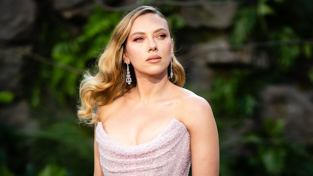 Scarlett Johansson poses in figure-hugging red dress and diamond choker at Jurassic World premiere
