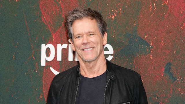 Kevin Bacon smiling in a black leather jacket at the premiere of The Bondsman in New York.