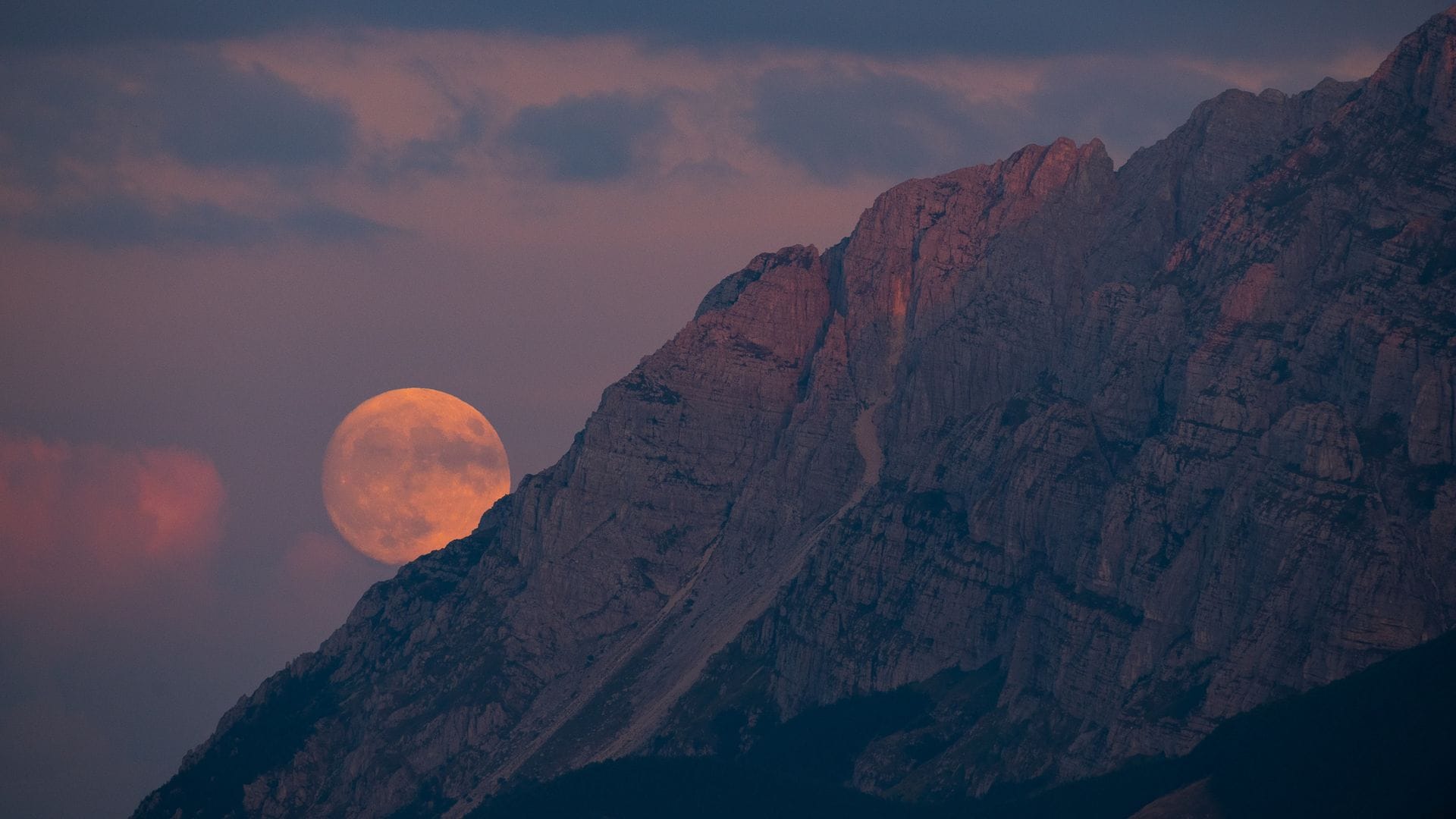 Sturgeon full super moon rising behind Sirente mountain is seen from Rocca Di Cambio (L'Aquila, Abruzzo), Italy on July 31, 2023. 
