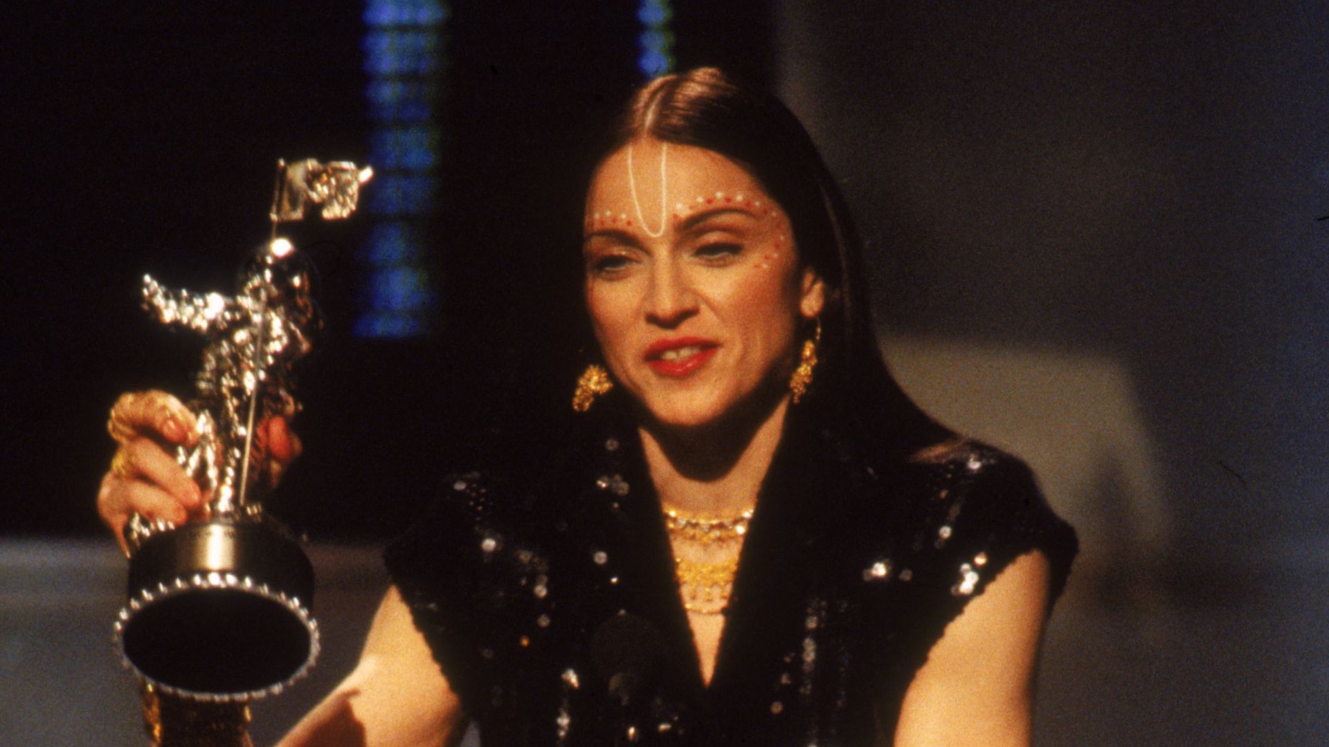 American pop singer Madonna,on stage at the '1998 MTV Video Music Awards' show, accepts an award for her video 'Ray of Light,' Los Angeles, California, May 31, 1998. (Photo by Frank Micelotta/Getty Images)