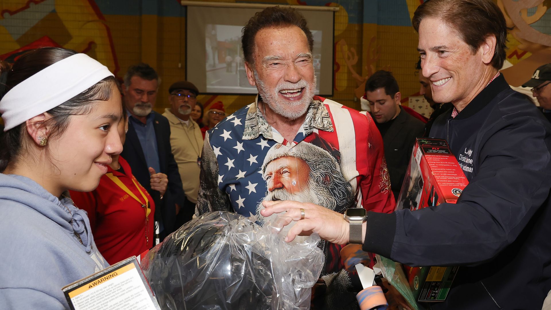 Arnold Schwarzenegger celebrates Christmas early, dressing up and giving presents to kids