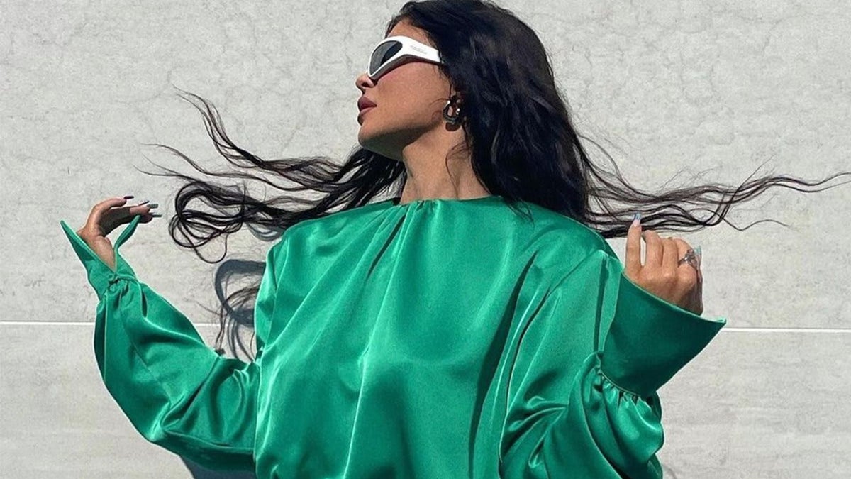 kylie jenner neon green dress wears mini with matching Chanel handbag sequin shirt