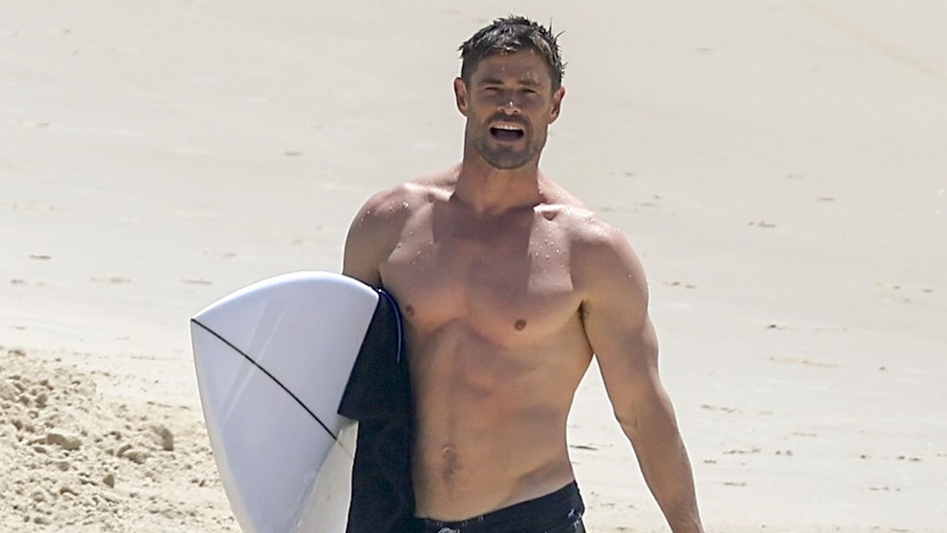 Chris Hemsworth proves he’s a proud dad as he returns to Byron Bay to cheer on son Sasha at surf competition
