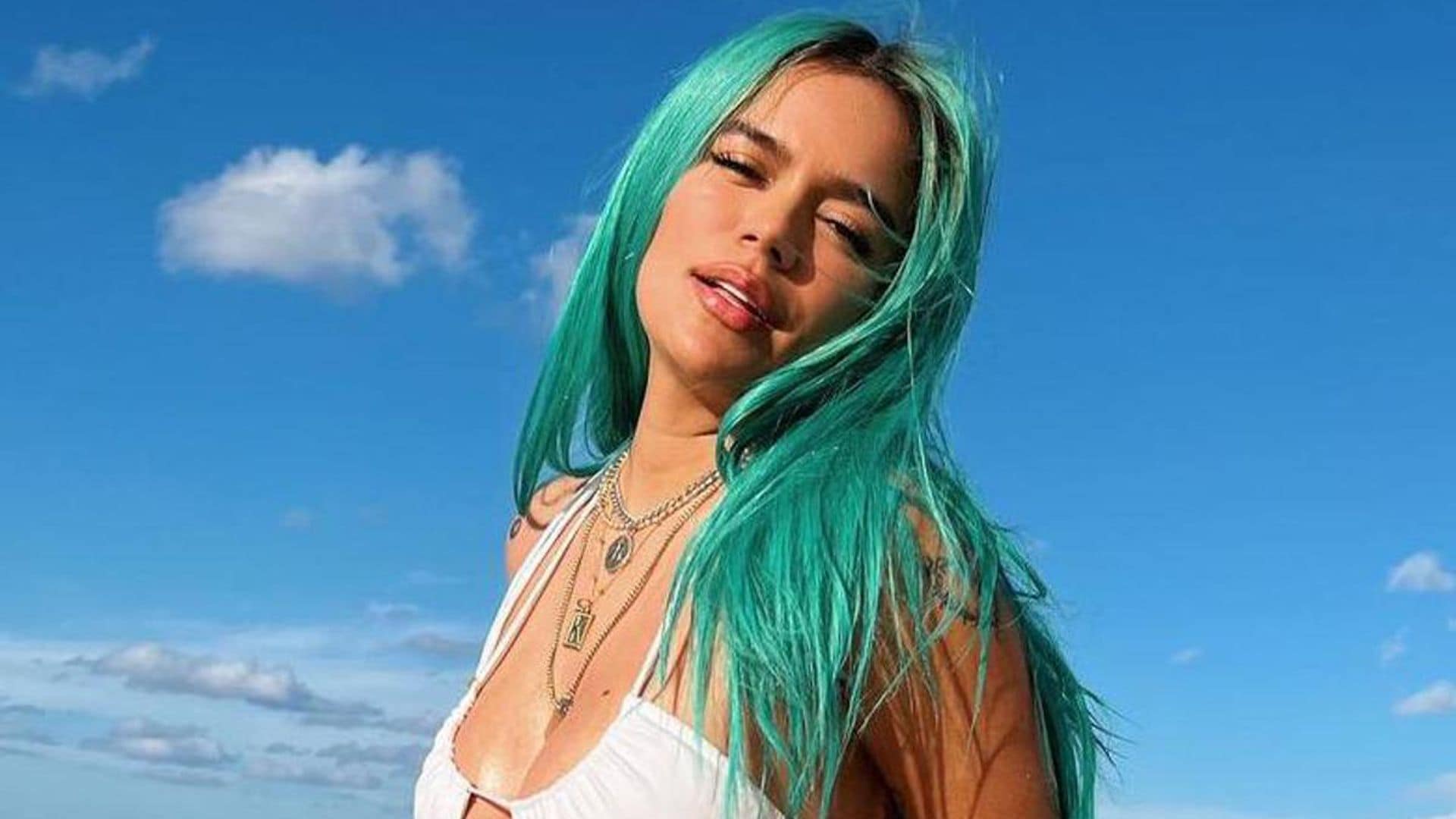 Karol G poses with makeup-free and flawless dewy skin for a cover shoot