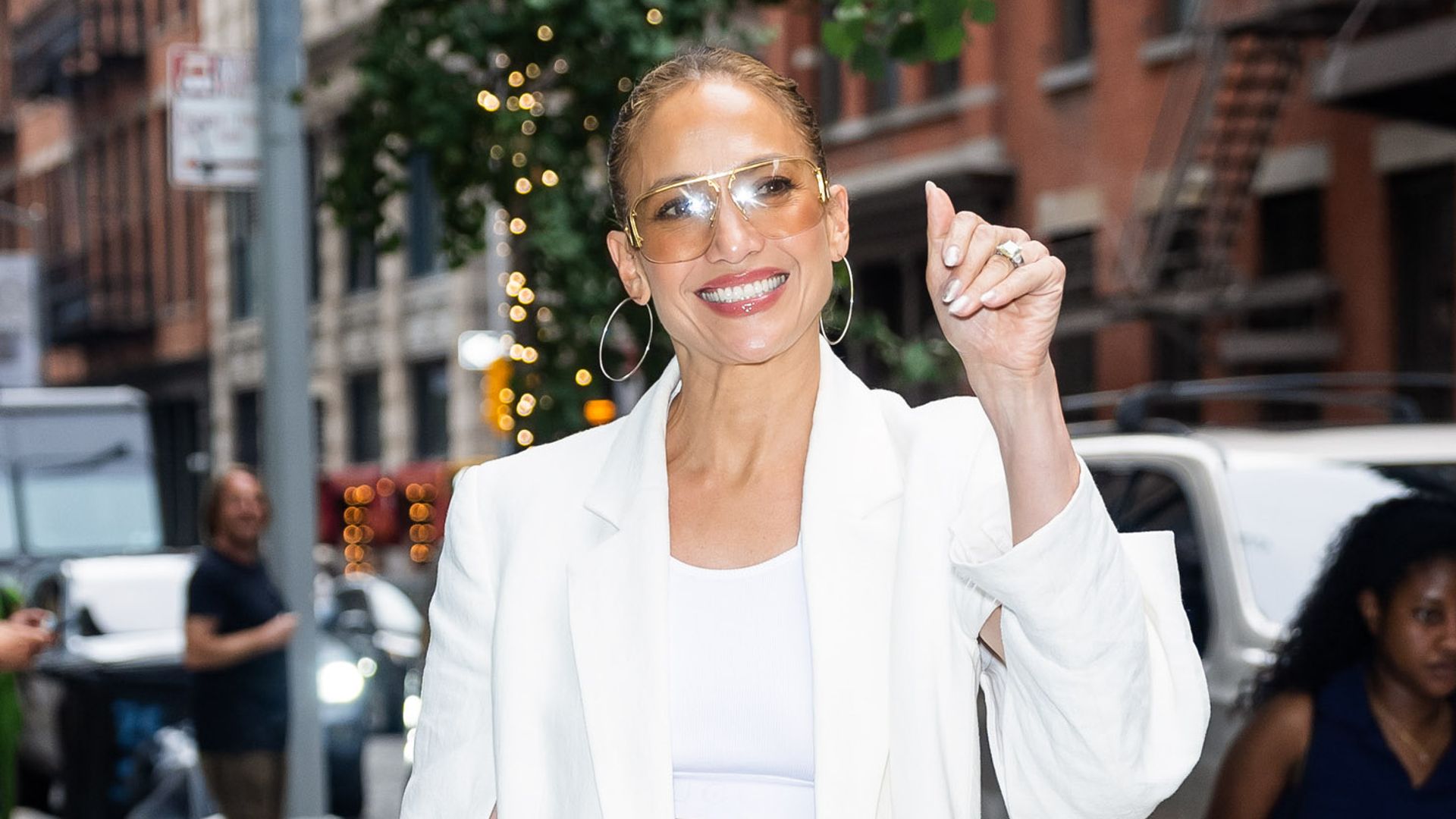 Jennifer Lopez is all smiles in NYC wearing white crop top and wedge platforms