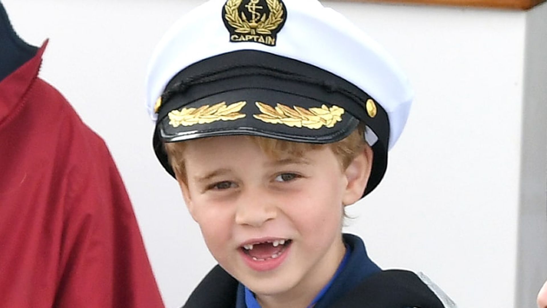 'Sailor' Prince George shows off his missing front teeth