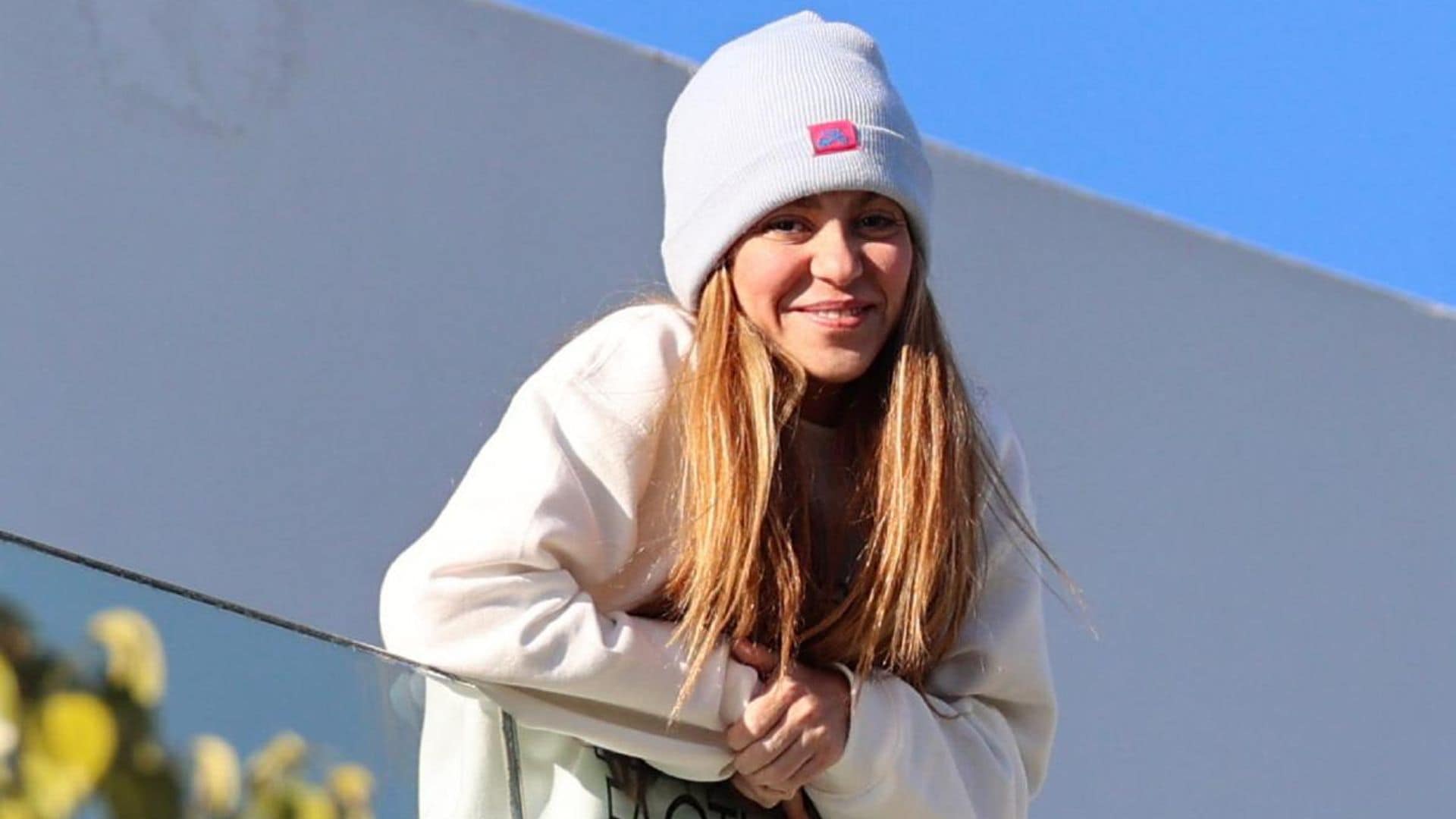Shakira salutes fans from balcony wearing jumper with lyrics to her controversial song about Piqué