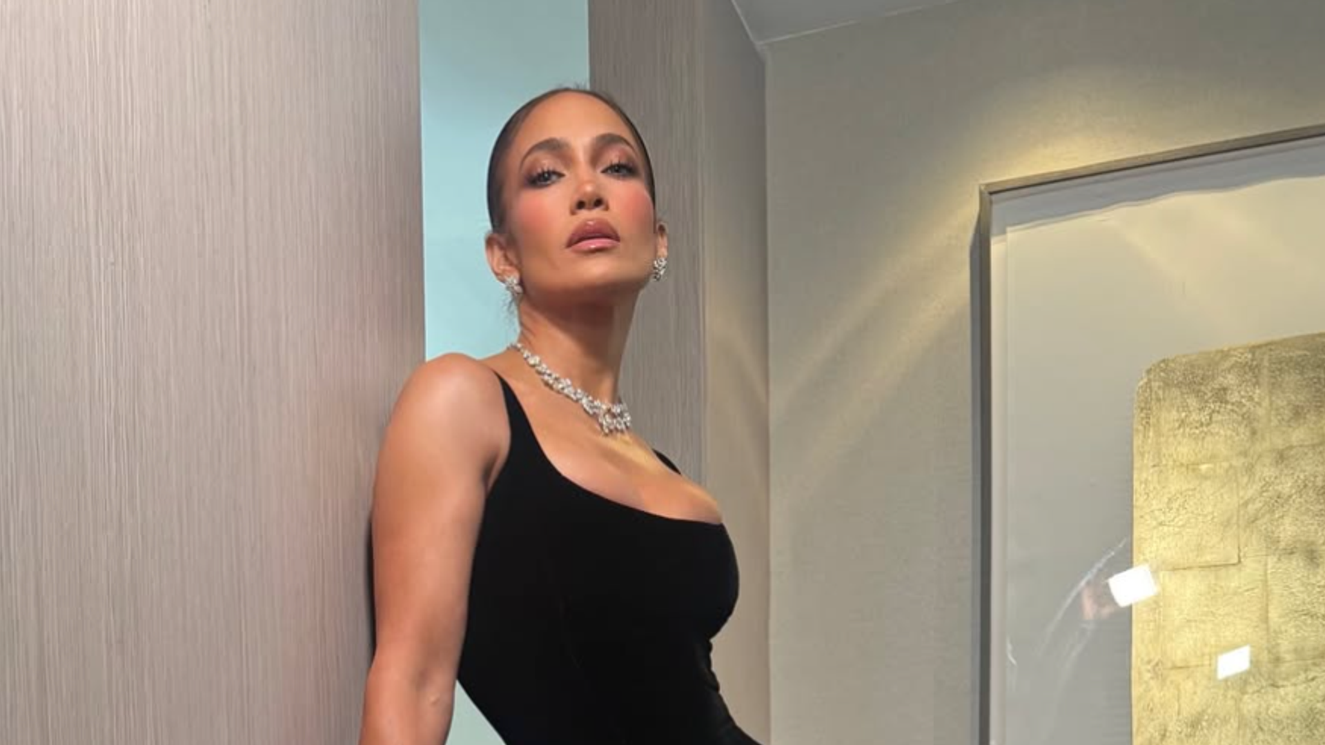 Jennifer Lopez turned heads in a glamorous black velvet gown and dazzling diamond jewelry while attending Taylor Swift and Travis Kelce's celebrity-filled wedding.