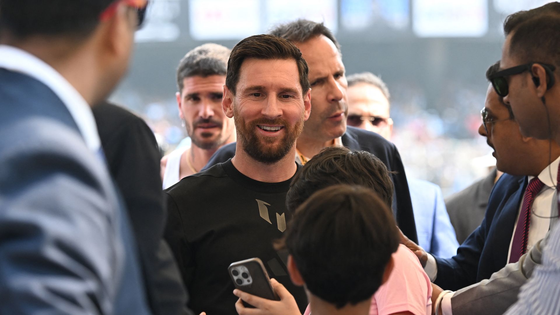 A fan takes a selfie with Inter Miami's Argentine forward #10 Lionel Messi at the Salt Lake Stadium in Kolkata on December 13, 2025. Thousands of fans packed into a stadium in eastern India on December 13 to cheer on Lionel Messi as the football legend unveiled a 21-metre (70-foot) statue of himself. (Photo by Dibyangshu SARKAR / AFP via Getty Images) 