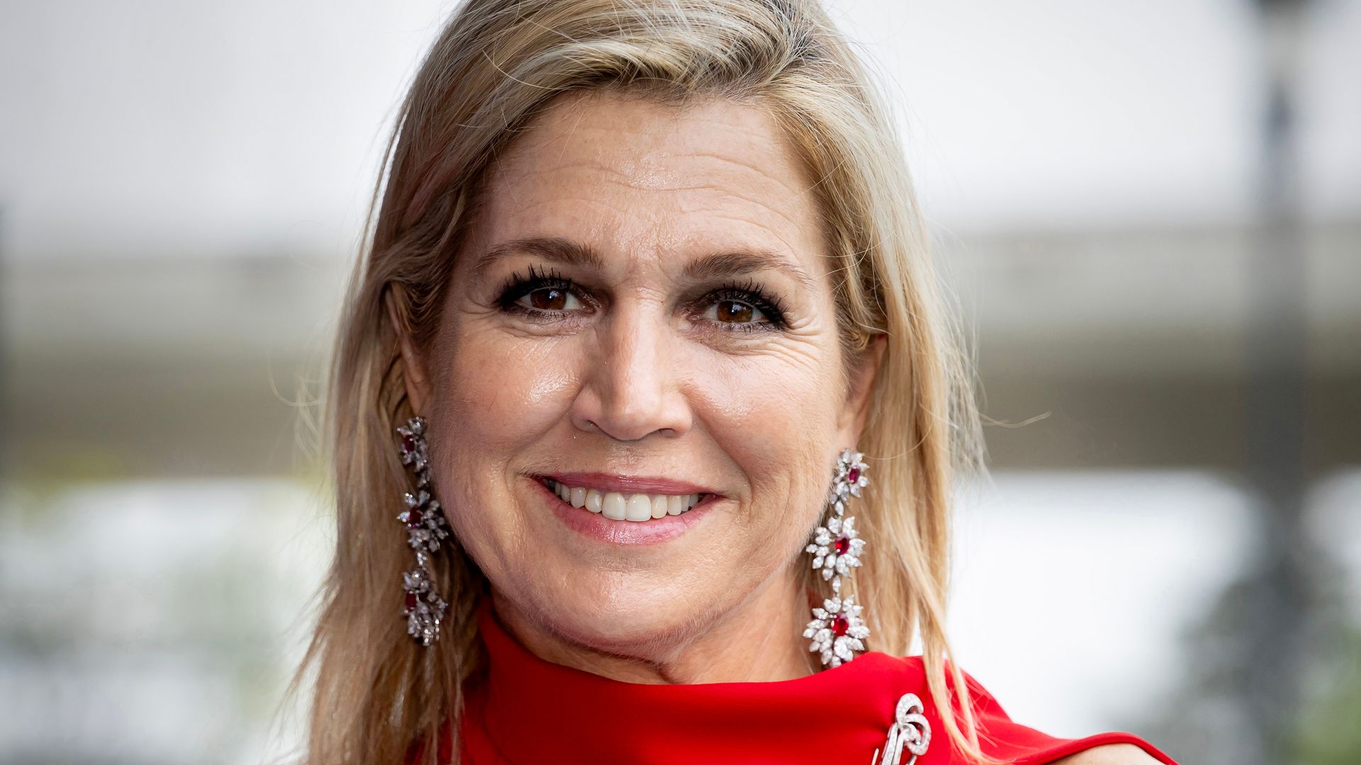 Queen Máxima of the Netherlands embraces polished feminine silhouette in bold yellow ensemble with luminous beauty look