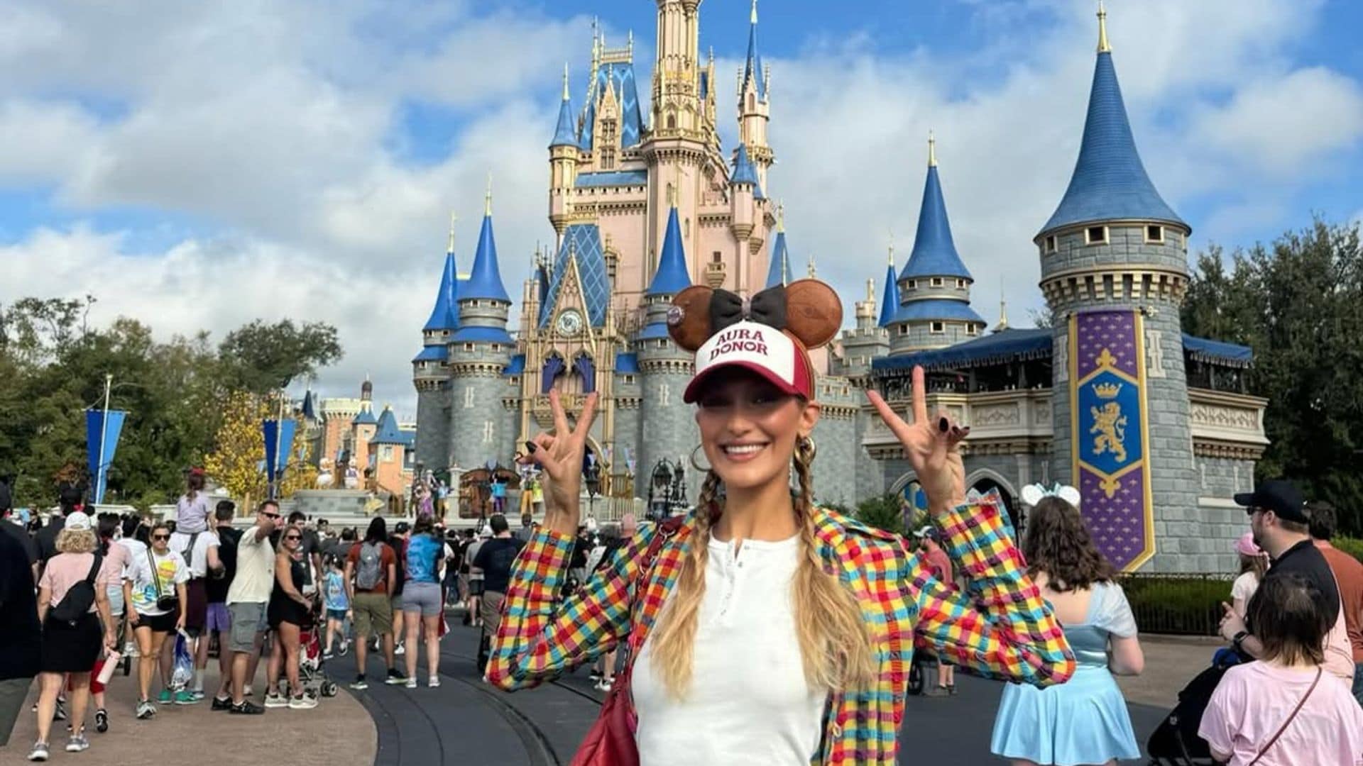 Hadid standing next to Cinderella's castle