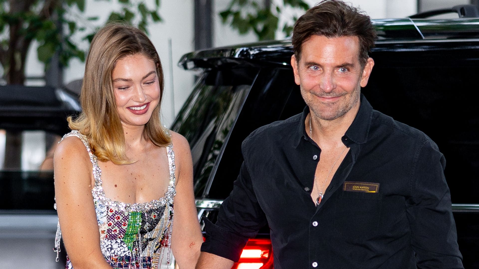 Bradley Cooper and Gigi Hadid hold hands as they leave Broadway date