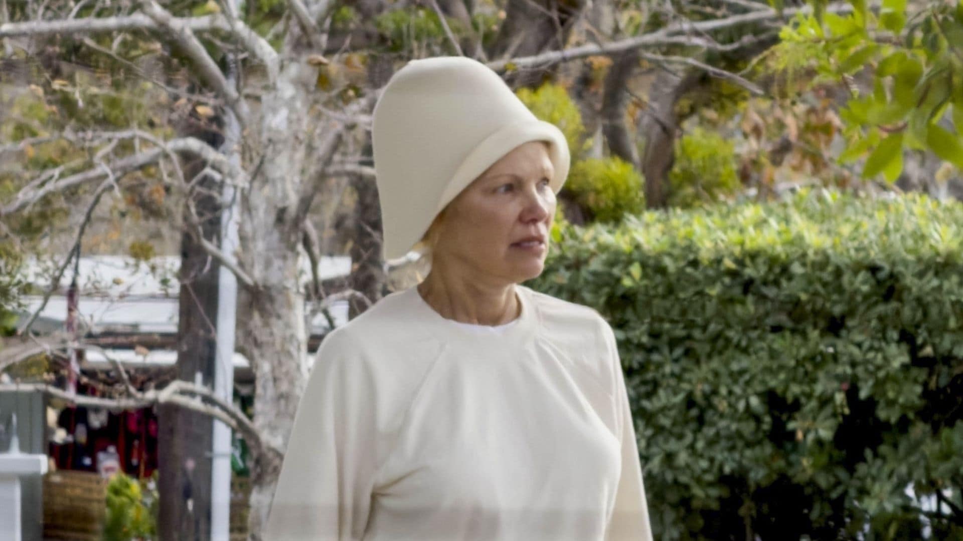 Pamela Anderson looks unrecognizable as she goes makeup-free in all-white look and bold hat