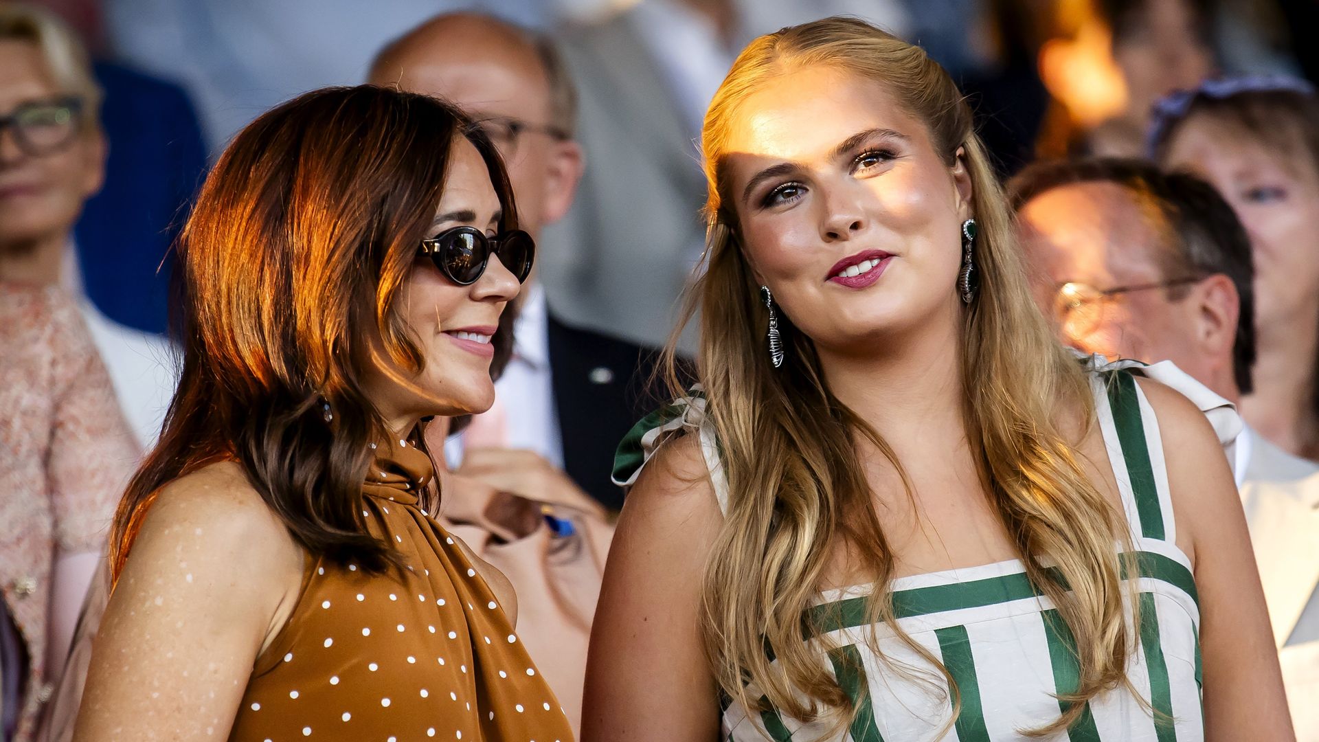Queen Mary is all smiles in a chic polka-dot dress as Princess Amalia shines in white and emerald green