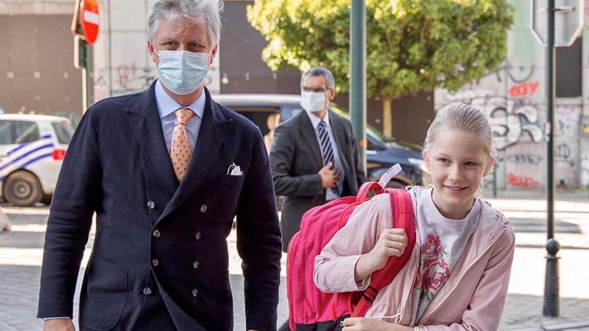 Belgium’s King Philippe stays protected as he escorts Princess Eléonore back to school