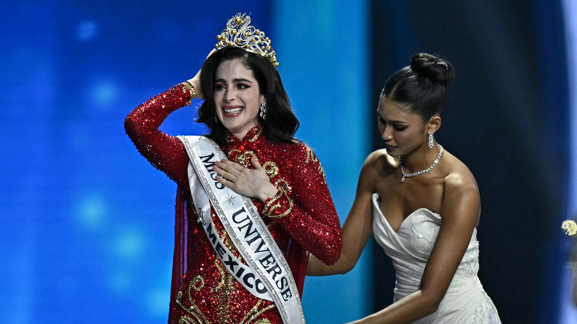Miss Mexico Fatima Bosch (L) celebrates winning the 2025 Miss Universe pageant in Nonthaburi, north of Bangkok, on November 21, 2025. (Photo by Lillian SUWANRUMPHA / AFP) (Photo by LILLIAN SUWANRUMPHA/AFP via Getty Images)