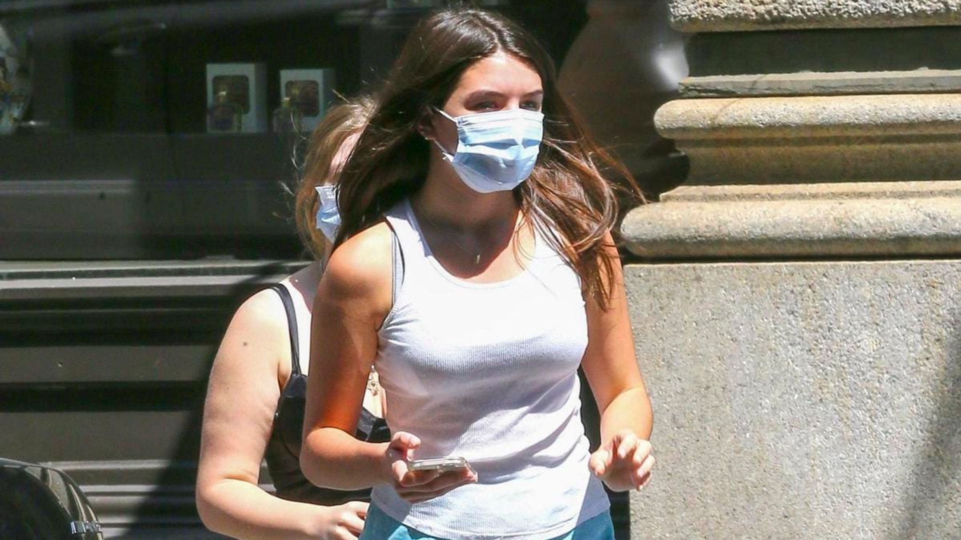 Suri Cruise rocks her favorite blue sneakers and goes on a stroll with her friend