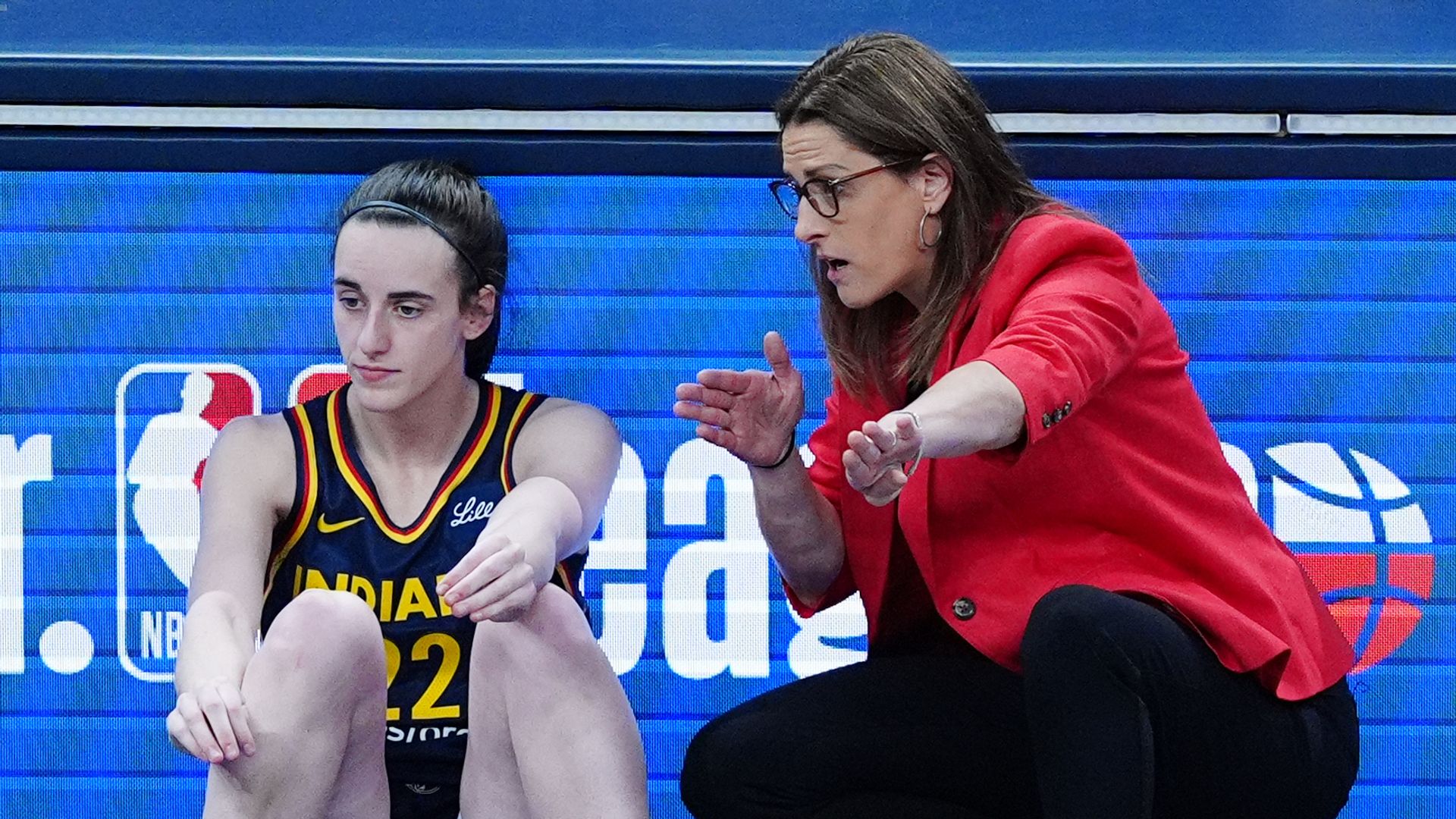 INDIANAPOLIS, IN - JULY 13: Indiana Fever coach Stephanie White talks to guard Caitlin Clark (22) as she waits to check into a game against the Dallas Wings on July 13, 2025, at Gainbridge Fieldhouse in Indianapolis, Indiana. (Photo by Brian Spurlock/Icon Sportswire via Getty Images) 
