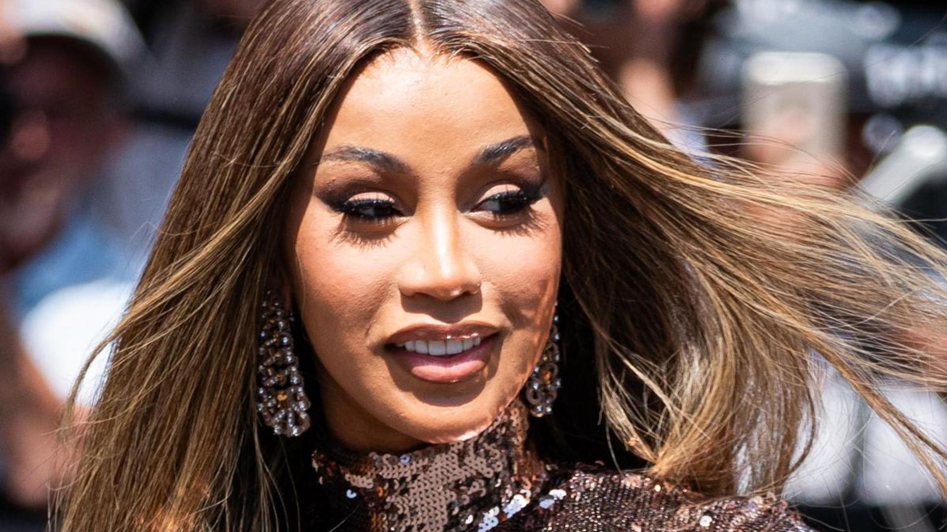 Is Cardi B in legal trouble after throwing mic at concertgoer?