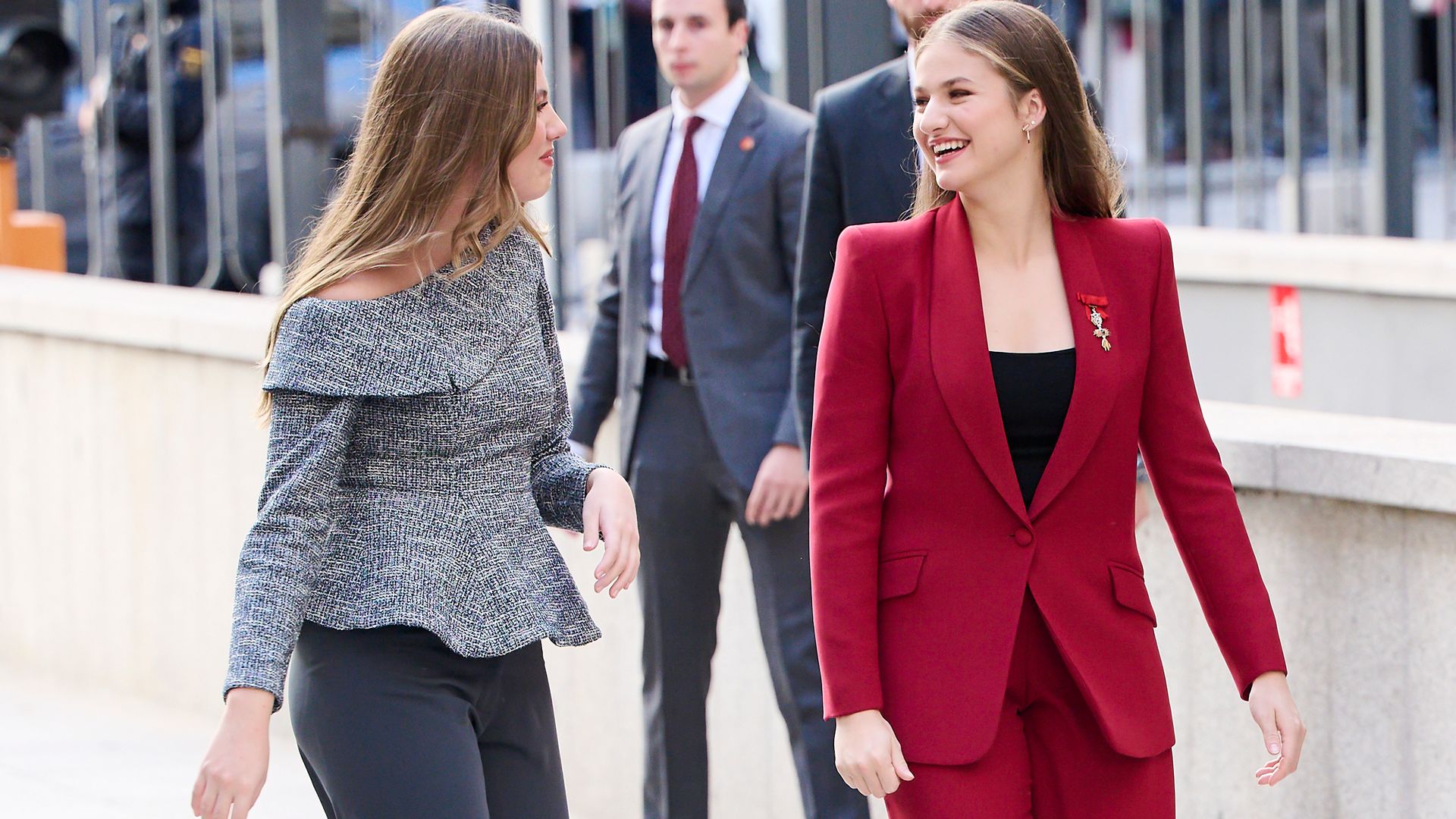 Princess Leonor and Infanta Sofía walking closely together, reflecting their strong sisterly bond.