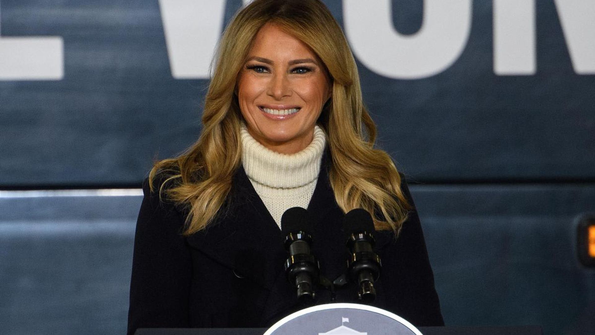 First Lady Melania Trump spreads holiday cheer wearing festive heels!