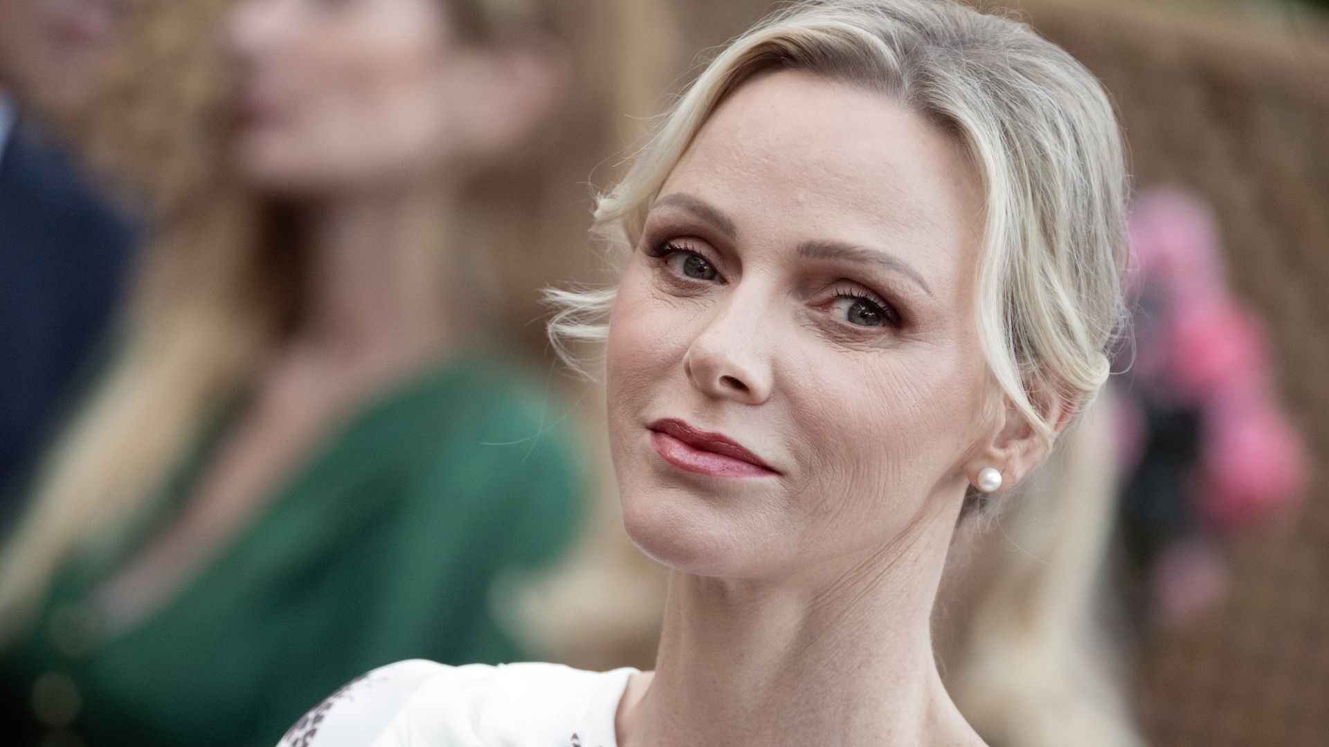 Princess Charlene channels Grace Kelly with a chic hairstyle and a modern power suit