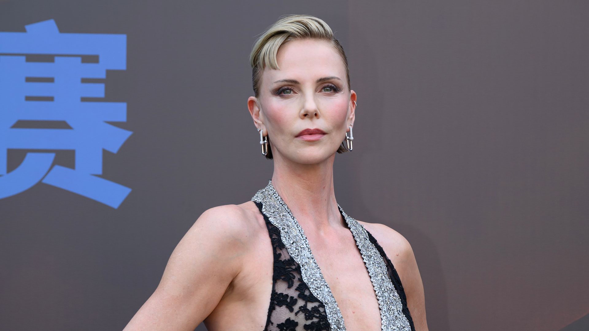 Charlize Theron unveils dramatic new look with edgy baby bangs and daring sheer gown
