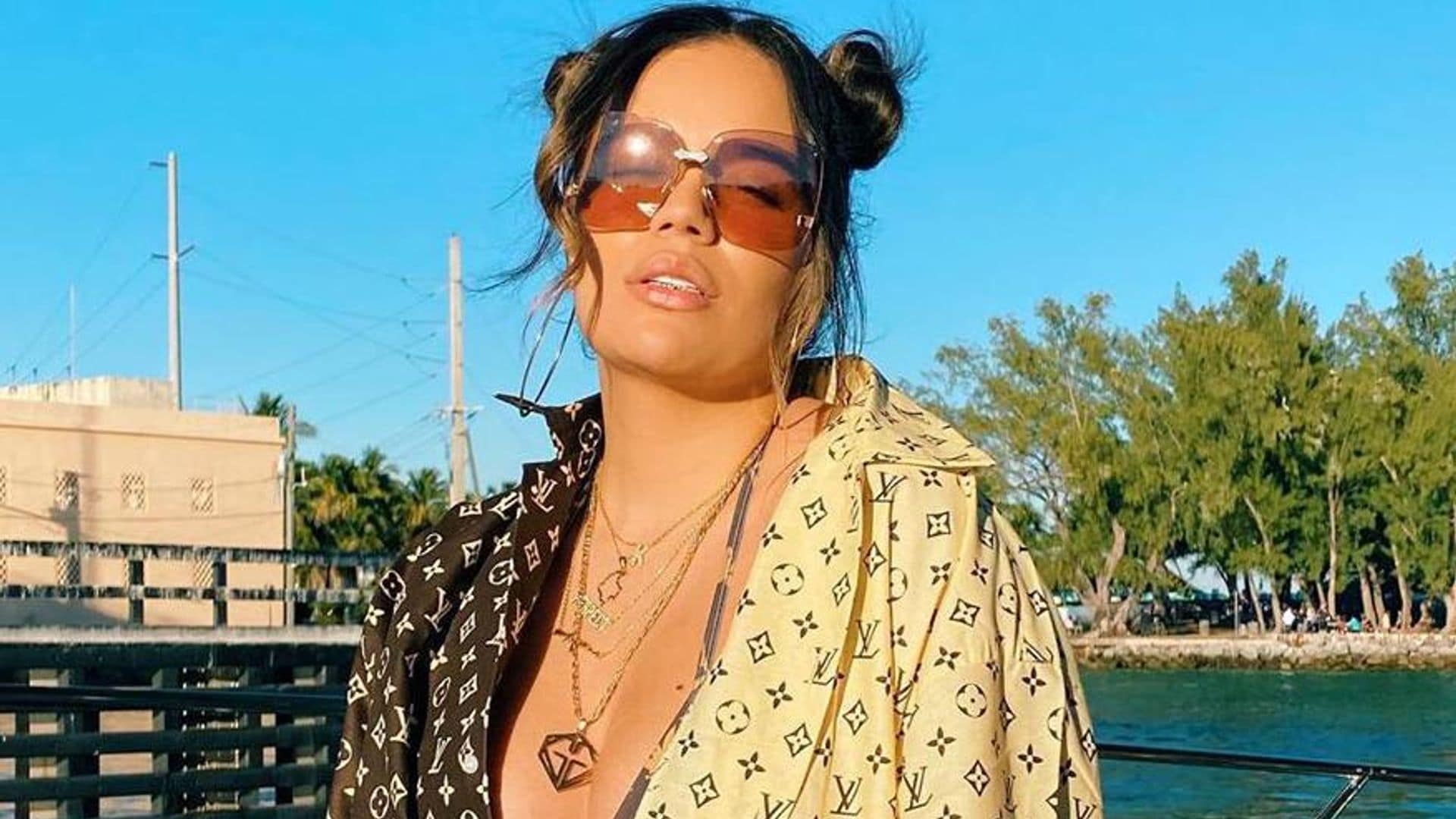 Karol G enjoys sun and shows off her curves in a fiery red bikini