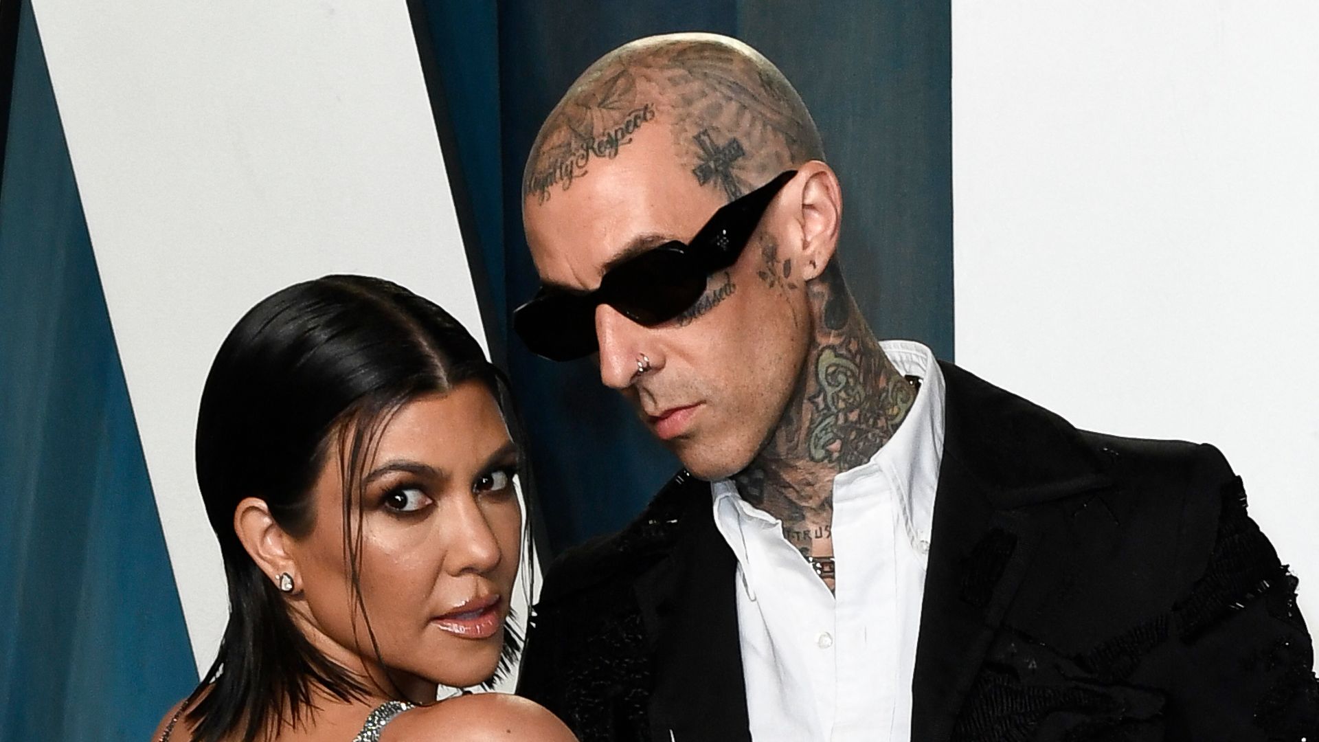 US musician Travis Barker and Kourtney Kardashian attend the 2022 Vanity Fair Oscar Party following the 94th Oscars at the The Wallis Annenberg Center for the Performing Arts in Beverly Hills, California on March 27, 2022. (Photo by Patrick T. FALLON / AFP) (Photo by PATRICK T. FALLON/AFP via Getty Images)