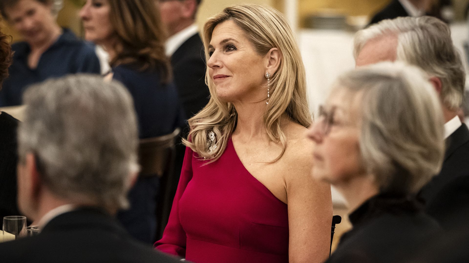 Queen Máxima gives her striking red gown a glamorous twist for royal palace dinner