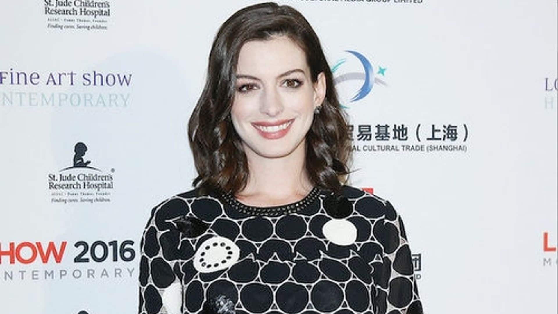 Anne Hathaway shows off her growing baby bump