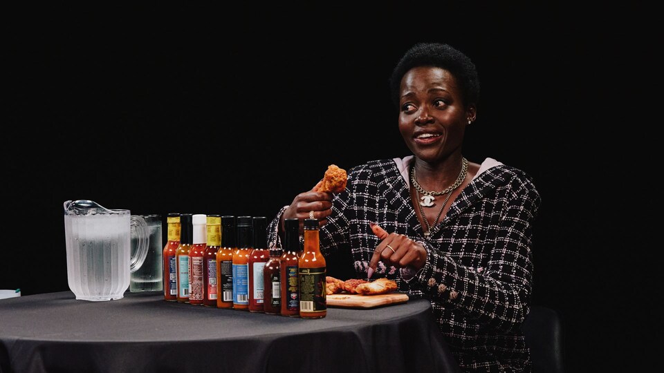 Lupita Nyong'o eats hot wings while discussing her fear of cats and