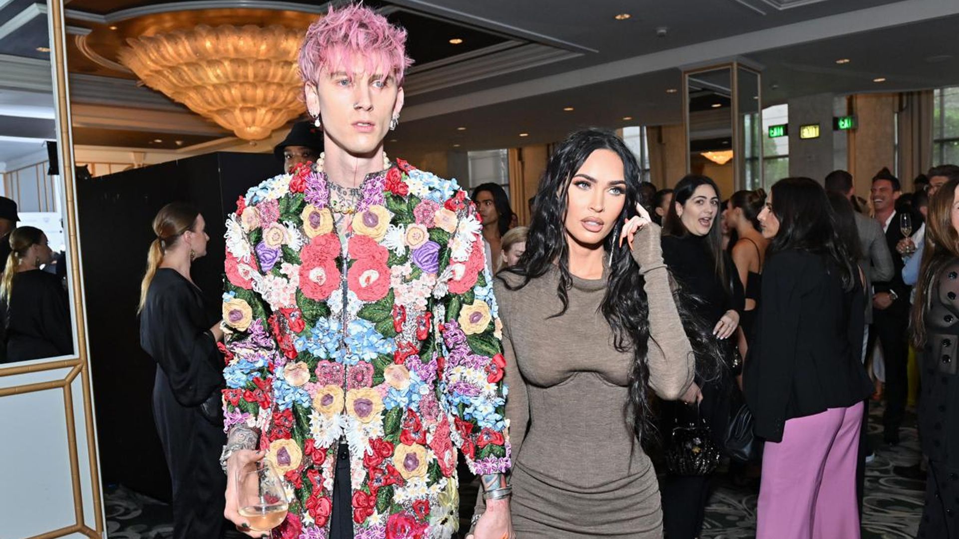 Megan Fox ducks away from Machine Gun Kelly’s kisses in awkward red carpet moment