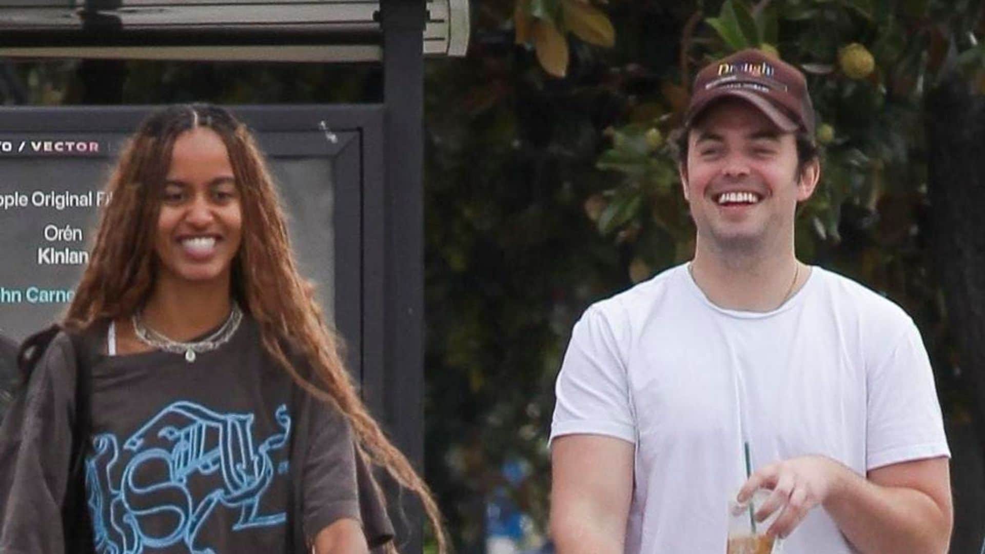Malia Obama giggles with a friend while wearing the perfect fall look