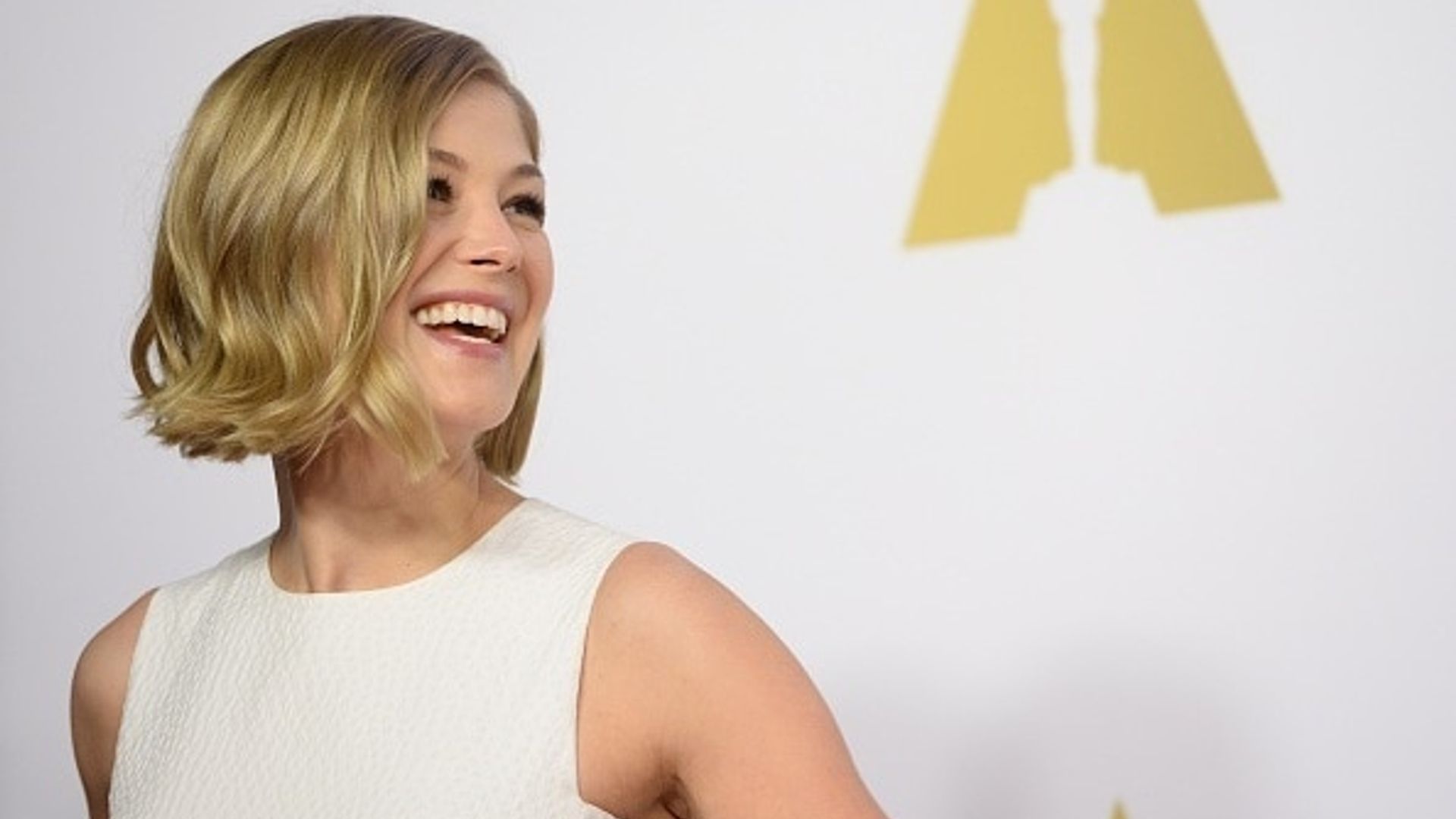 Rosamund Pike is a vision in white at Oscars Nominee Luncheon