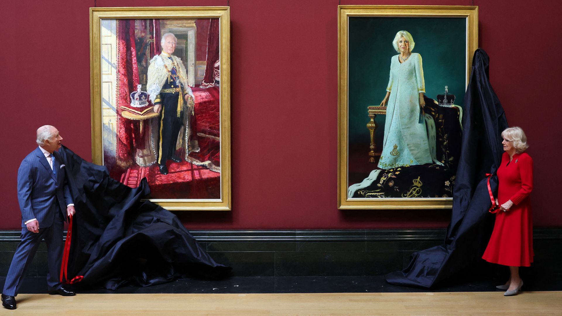TOPSHOT - Britain's King Charles III and Britain's Queen Camilla unveil their official Coronation State Portraits during a visit to The National Gallery, in central London, on May 6, 2025. (Photo by Chris Jackson / POOL / AFP) (Photo by CHRIS JACKSON/POOL/AFP via Getty Images)          