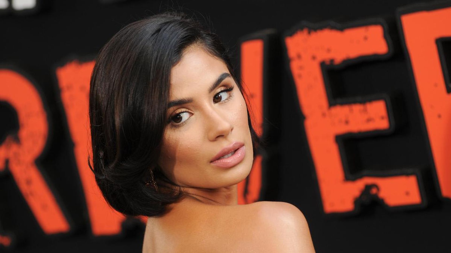 Diane Guerrero is pondering retouching her wrist tattoo in support of trans lives