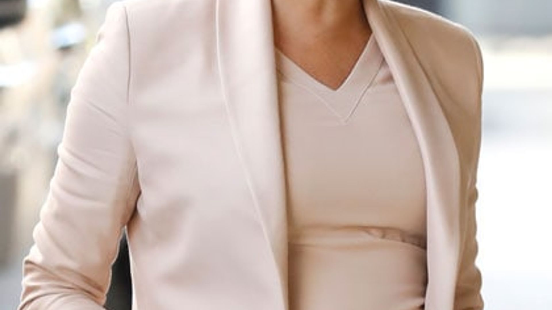 Meghan Markle looks pretty in peach during her visit to the National Theater