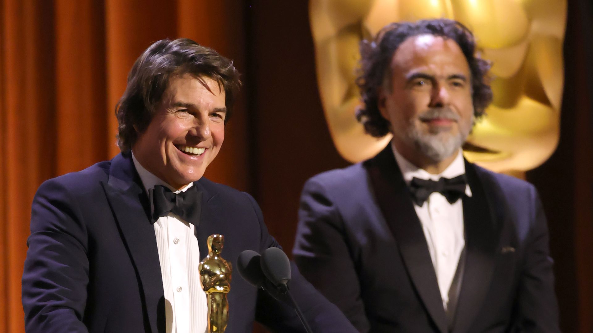 HOLLYWOOD, CALIFORNIA - NOVEMBER 16: (L-R) Tom Cruise accepts an Academy Honorary Award from Alejandro González Iñárritu onstage during the 16th Governors Awards at The Ray Dolby Ballroom on November 16, 2025 in Hollywood, California. (Photo by Kevin Winter/Getty Images)