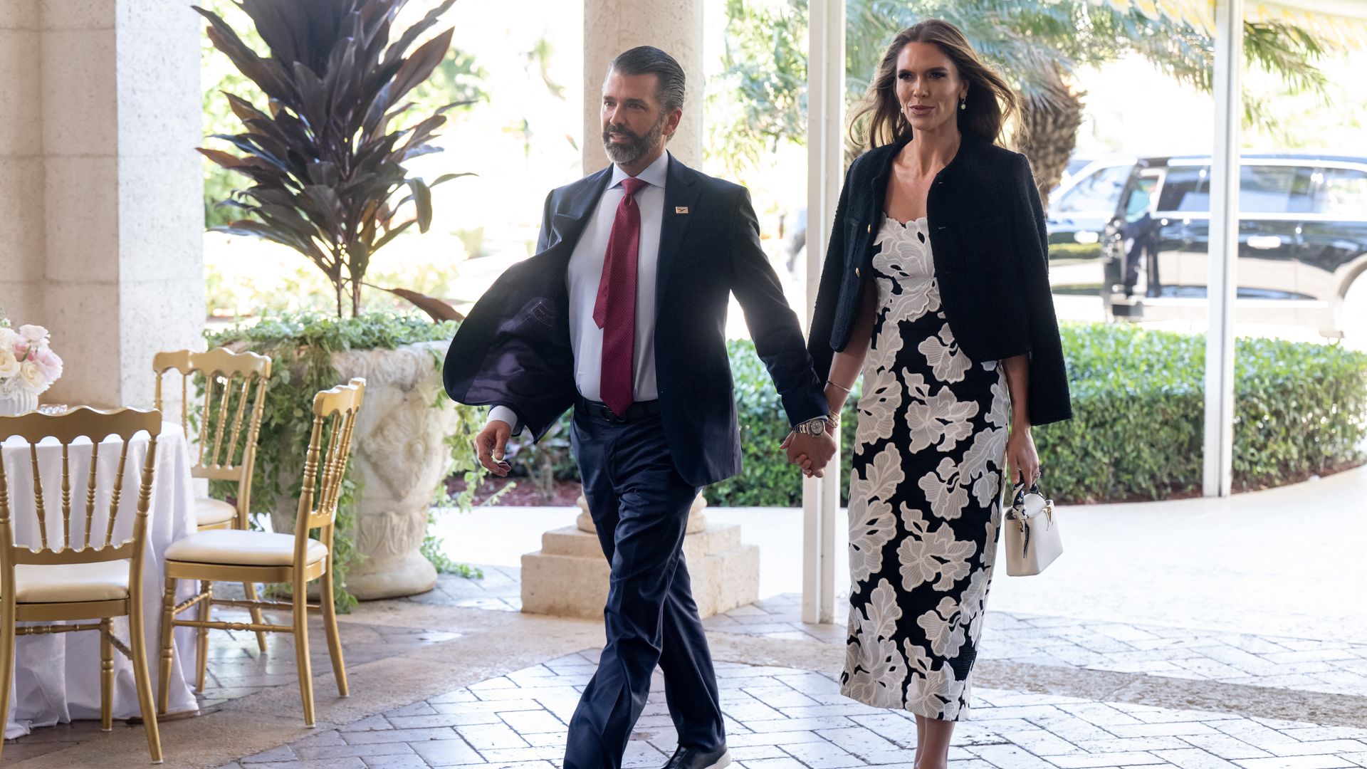 (L/R) Donald Trump Jr. and his fiancee Bettina Anderson arrive to attend the wedding of Dan Scavino