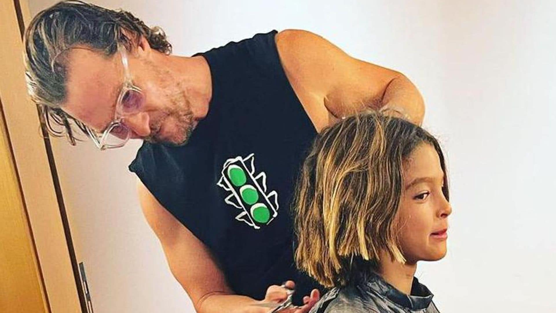 Matthew McConaughey plays barber and gives his son Livingston a haircut
