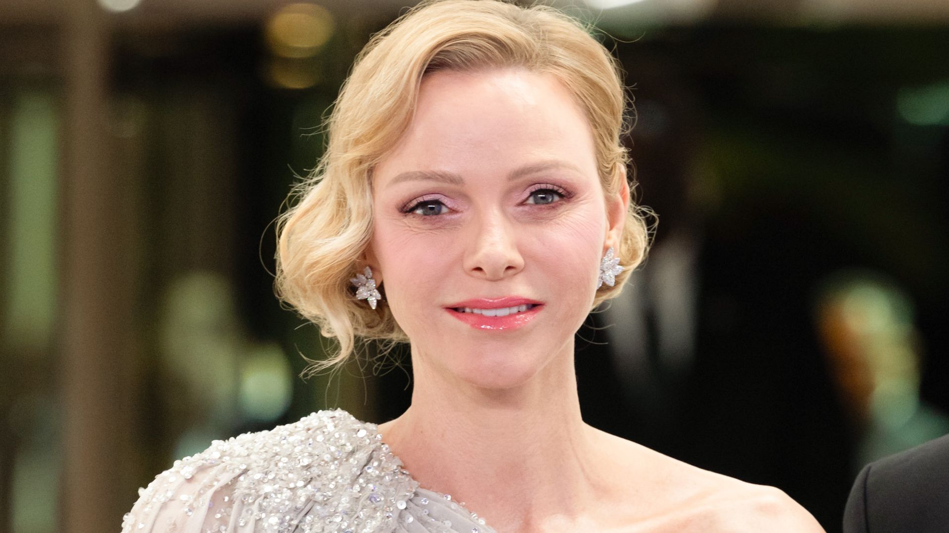 Princess Charlene’s Rose Ball 2026 look: dramatic silver cape gown, diamond jewelry, and her signature soft glam