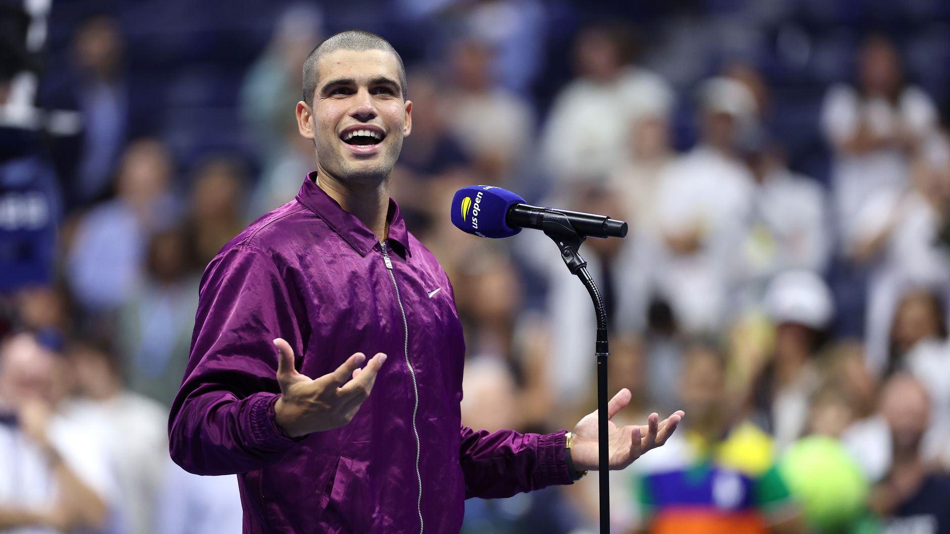  Carlos Alcaraz of Spain speaks to the crowd after defeating Reilly Opelka of the United States during their Men's Singles First Round match on Day Two of the 2025 US Open 