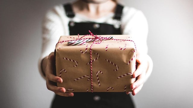 A person hold a Christmas gift.