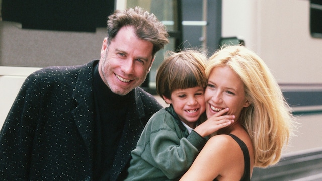 Actress Kelly Preston gets a visit from husband John Travolta (L) and son Jett while on location filming the 1997 motion picture "Addicted to Love."    