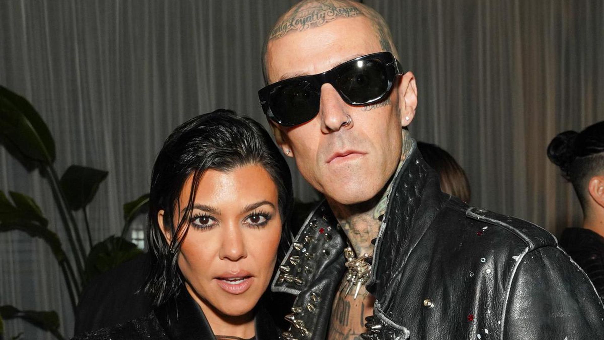Kourtney Kardashian shows off her baby bump in an itty bitty red bikini